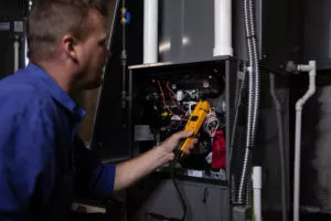  Technician maintaining a furnace 