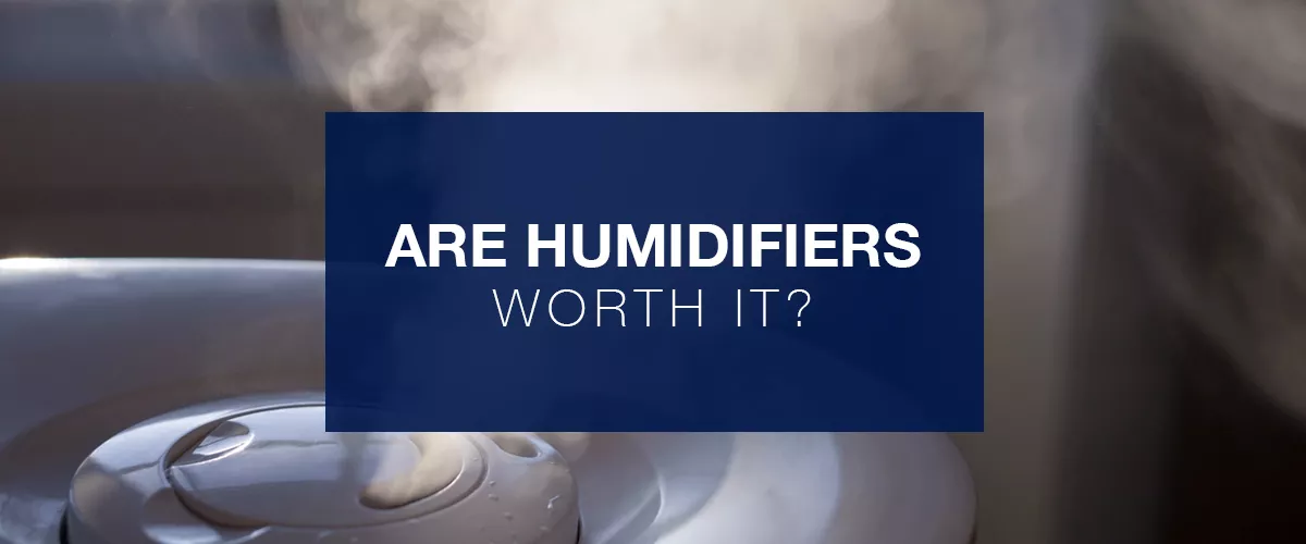  Text "Are humidifiers worth it?" in blue square over image of humidifier emitting moisture into air. 