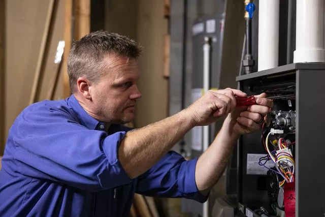  hvac technician performing emergency repairs 